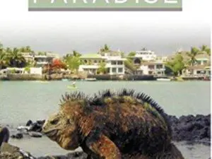 Marine iguana on rocky shore near village