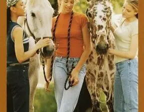 Three girls with two horses on cover
