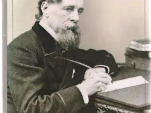 Bearded man writing at ornate desk
