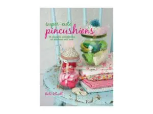 Colorful handmade pincushions in glass jars