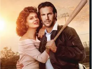 Couple embracing with baseball bat