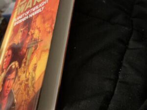 Star Wars paperback book on black blanket