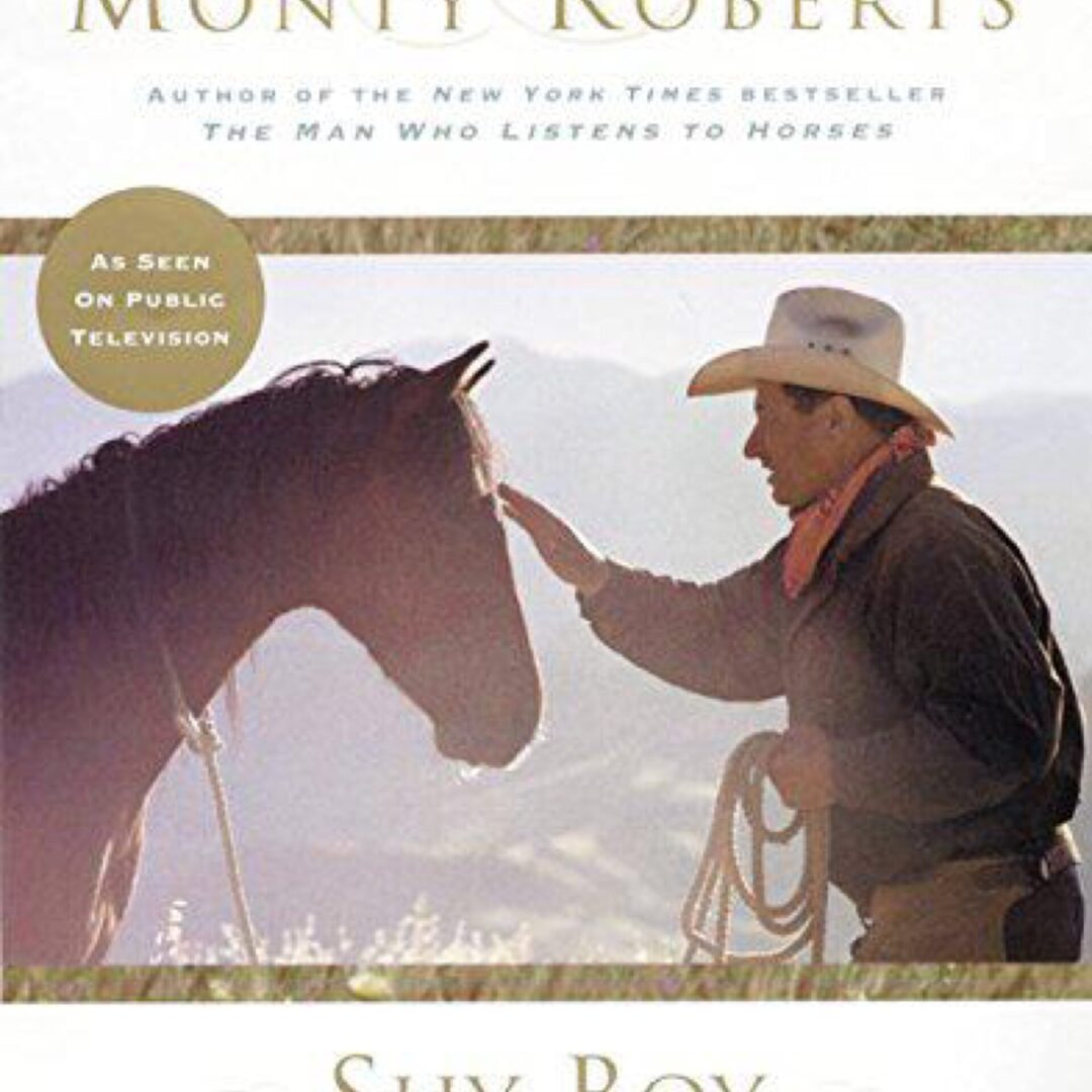 Man in cowboy hat petting horse outdoors