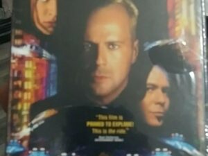 Movie poster with three faces and futuristic vehicles