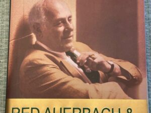 Older man in suit reclining, holding cigar