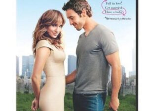 Romantic couple in park, woman holding baby shoes