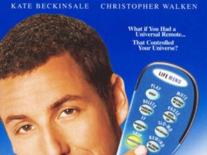 Smiling man holding large blue TV remote